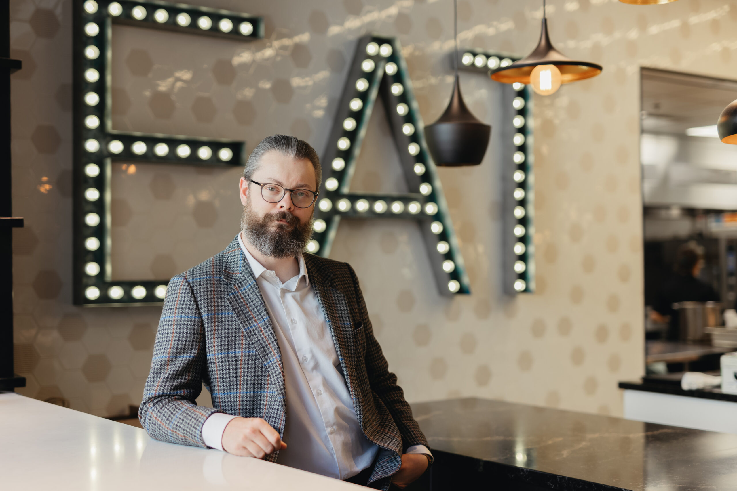 General Manager, Daniel, in front of EAT sign